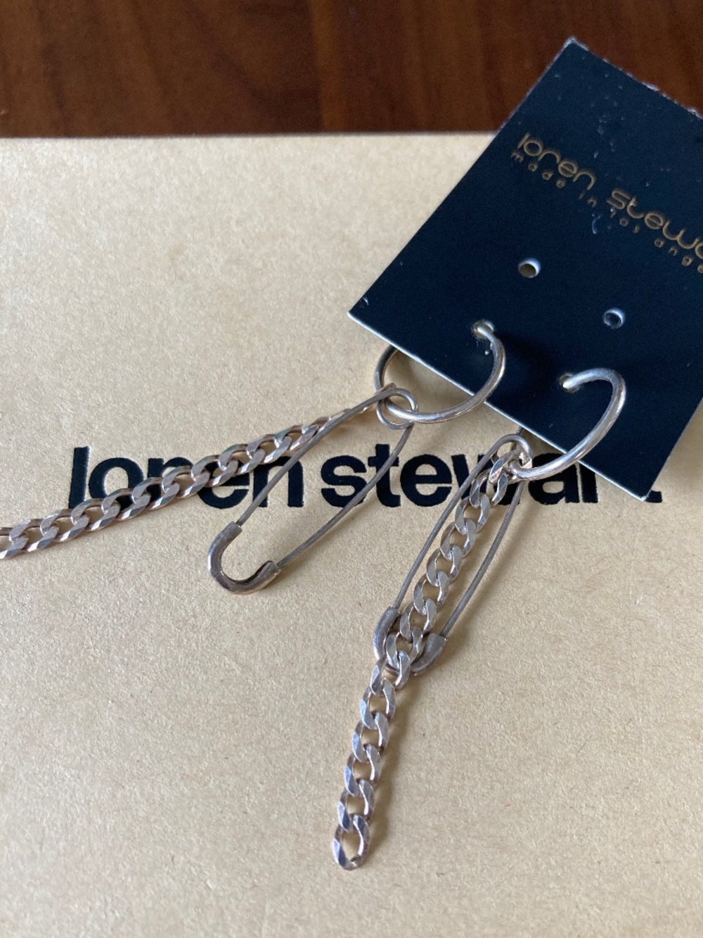 pair Loren Stewart sterling silver charm hoops with chain and safety pin charms